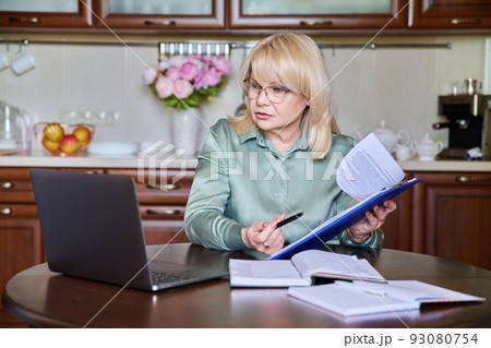Senior business woman working remotely using laptop for video call 93080754