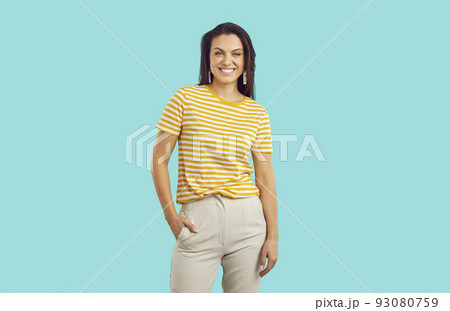 Portrait of beautiful happy millennial woman in casual clothes isolated on turquoise background. 93080759