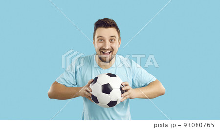 Overjoyed man with ball support football team Overjoyed man with ball support football team 93080765