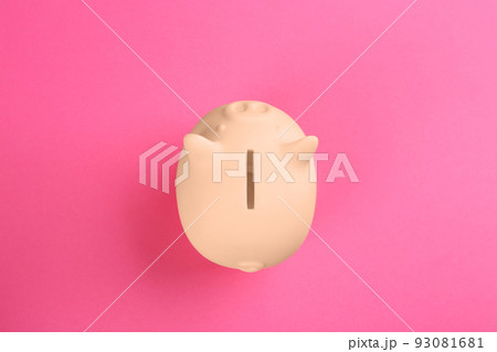 Beige piggy bank on pink background, top view 93081681