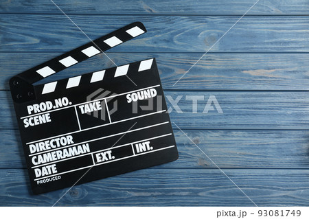 Clapper board on blue wooden background, top view with space for text. Cinema production 93081749