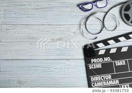 Flat lay composition with clapperboard, cinema reel and 3d glasses on white wooden table, space for text 93081750