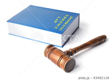 Domestic violence law book and wooden gavel on white background 93082116