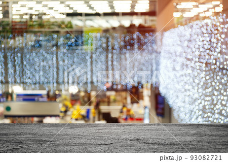 Empty stone surface and blurred view of Christmas decorations in shopping mall. Space for design 93082721