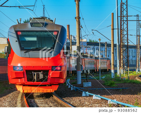 Six-car commuter train on the running along the railway track. Electrical multiple unit passenger suburban train in push-pull mode. 93088562