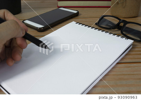 Hand with pen writing notebook on office desk table with. Copy space. Hand with pen writing notebook on office desk table with. Copy space. 93090963