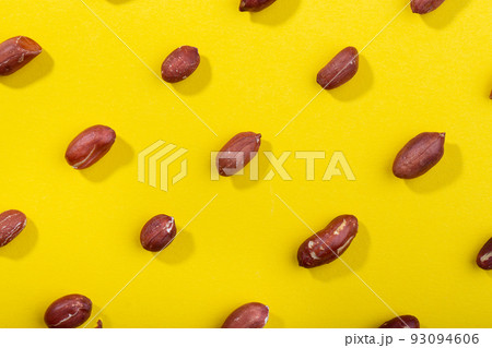 Pattern of peanuts. Fashionable sunny pattern of peanuts  on yellow background. 93094606