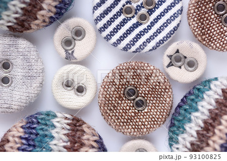 Button on white background. Fabric buttons collection closeup 93100825