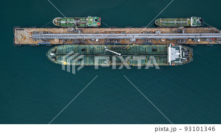 Aerial view tanker ship vessel unloading at port, Global business logistic import export oil and gas petrochemical with tanker ship transportation oil from dock refinery. Aerial view tanker ship vessel unloading at port, Global business logistic import export oil and gas petrochemical with tanker ship transportation oil from dock refinery. 93101346
