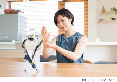 カメラの前でお勧め化粧品の動画を収録する女性 93101977