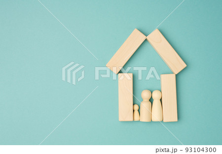 Wooden family figurines, model house on a blue background. Real estate purchase 93104300