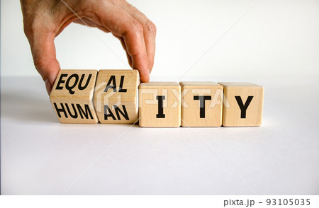 Equality and humanity symbol. Businessman turns wooden cubes and changes the word 'equality' to 'diversity'. Beautiful white background. Business, equality and humanity concept. Copy space. Equality and humanity symbol. Businessman turns wooden cubes and changes the word 'equality' to 'diversity'. Beautiful white background. Business, equality and humanity concept. Copy space. 93105035