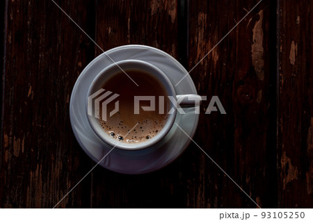A cup with coffee on a table A cup with coffee on a table 93105250