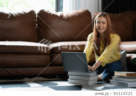 Image of Young woman with a headset working online on laptop computer. studying or working from home online concept. 93113525