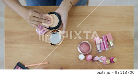 Woman using cosmetic and try to make up following her vlogger 93113700