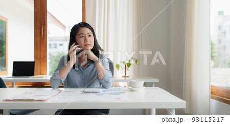 Portrait of Asian Business woman at work talking on phone. Finance Concept. Portrait of Asian Business woman at work talking on phone. Finance Concept. 93115217