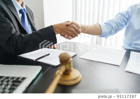 Lawyer and legal concept, Businessman and senior lawyer shake hands after successful deal contract Lawyer and legal concept, Businessman and senior lawyer shake hands after successful deal contract 93117287