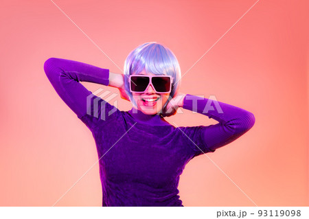 Cyber punk girl concept, happy asian woman in purple sweatshirt wearing sunglasses posing like robot. isolated on red color background. Cyber punk girl concept, happy asian woman in purple sweatshirt wearing sunglasses posing like robot. isolated on red color background. 93119098