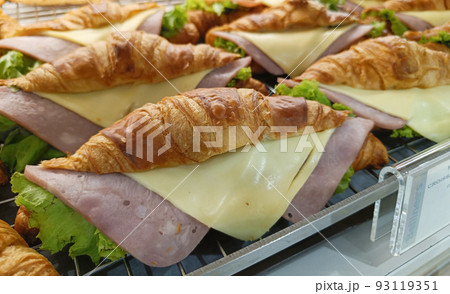 Closeup view. Croissant with ham and cheese on tray. Closeup view. Croissant with ham and cheese on tray. 93119351