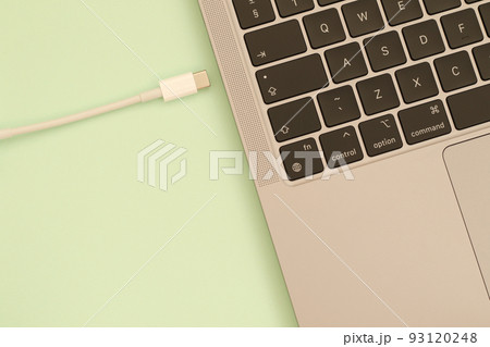 usb c cable and laptop keyboard on green background usb c cable and laptop keyboard on green background 93120248