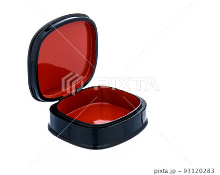 Round Oval Black and red lacquered wooden casket with golden floral pattern on white background. Empty open casket for storing accessories, small items, valuables and jewelry. Luxury gift packaging. 93120283