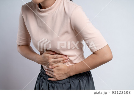 Asian woman was sick with stomach ache standing isolated on white background. Asian woman was sick with stomach ache standing isolated on white background. 93122108