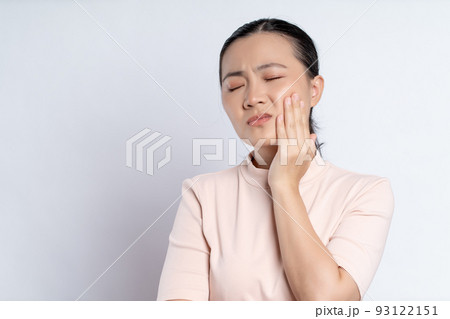 Asian woman was sick with toothache standing isolated on white background. Asian woman was sick with toothache standing isolated on white background. 93122151