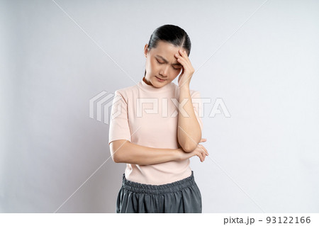 Asian woman was sick with headache standing isolated on white background. Asian woman was sick with headache standing isolated on white background. 93122166