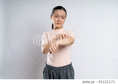 Asian woman was sick with irritate itching her skin standing isolated on white background. Asian woman was sick with irritate itching her skin standing isolated on white background. 93122171