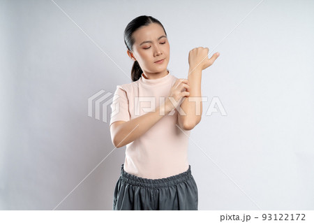 Asian woman was sick with irritate itching her skin standing isolated on white background. Asian woman was sick with irritate itching her skin standing isolated on white background. 93122172