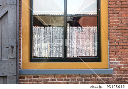 Window of cozy house with vintage curtains Window of cozy house with vintage curtains 93123016