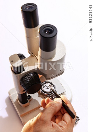 Use of special equipment for watch repair. Closeup watchmaker's hands with work tools. Concept of vintage retro mechanisms, job, work, ad 93125545