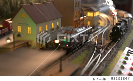 Steam locomotive model train. Scale model railway layout with steam locomotives. Model train station in miniature. Steam locomotive model train. Scale model railway layout with steam locomotives. Model train station in miniature. 93131847