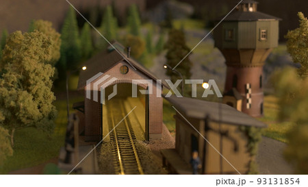 Depot station on the model of the railway road. Model train station at miniature forest. 93131854