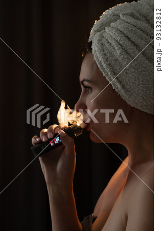 A girl is vaping, a vaper releases smoke from her mouth, electronic cigarettes and a girl close-up. 93132812