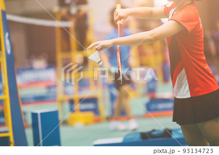 Badminton professional player serve shuttlecock in action game match competition Badminton professional player serve shuttlecock in action game match competition 93134723