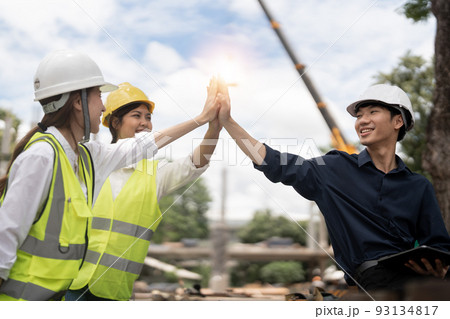 Engineers people join hands to build successful projects. Teamwork concept. Engineers people join hands to build successful projects. Teamwork concept. 93134817