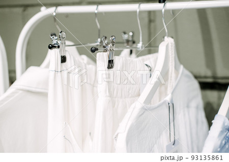 Sustainable fashion, slow fashion. Close Up Shot of Clothing Rack with natural tones clothes Sustainable fashion, slow fashion. Close Up Shot of Clothing Rack with natural tones clothes 93135861
