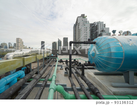 Chiller tower or cooling tower on rooftop of a office building in urban city. System work. Architecture machine. Condenser Water Supply and Condenser Water Return pipe lines. Ventilation compressor. 93136312