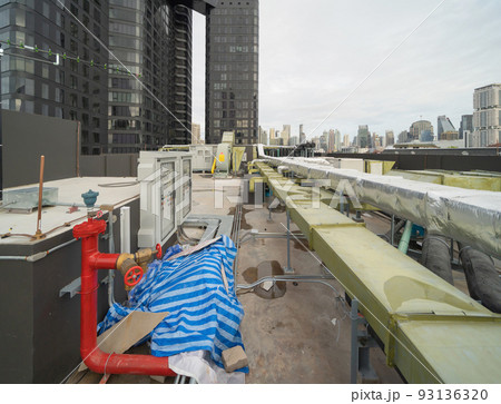 Chiller tower or cooling tower on rooftop of a office building in urban city. System work. Architecture machine. Condenser Water Supply and Condenser Water Return pipe lines. Ventilation compressor. 93136320