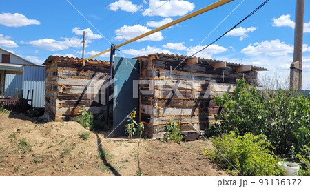 Garage shed made from railway sleepers, Small outbuilding near a private house 93136372