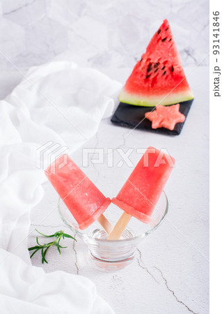 Watermelon popsicles in a bowl and a piece of watermelon. Homemade dessert. Vertical view 93141846