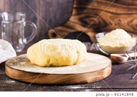 Ready raw dough for baking mexican tortillas on the board on the table. Homemade pastries 93141848