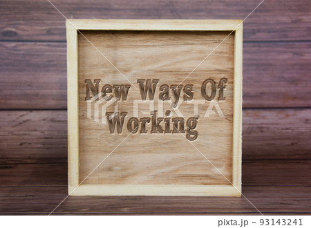New Ways Of Working text engraved on wooden frame. New business culture concept New Ways Of Working text engraved on wooden frame. New business culture concept 93143241