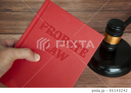 Hand holding Probate Law book with gavel background. Law concept Hand holding Probate Law book with gavel background. Law concept 93143242