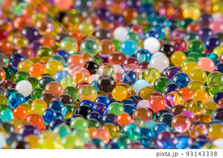 Water beads close-up, abstract background. Texture of Hydrogel balls or many colorful orbeez for wallpaper. 93143338