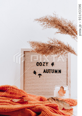 Autumn inscription on letter board. Cozy autumn. Hygge, autumn cozy mood, comfort concept Autumn inscription on letter board. Cozy autumn. Hygge, autumn cozy mood, comfort concept 93143396
