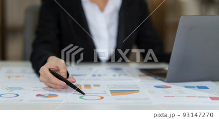 Businesswoman analyzes company's financial system and using calculator Businesswoman analyzes company's financial system and using calculator 93147270