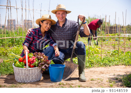 Happy family of gardeners posing with harvest of vegetables Happy family of gardeners posing with harvest of vegetables 93148559