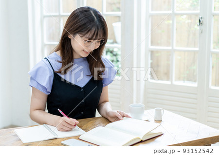 勉強する眼鏡をかけたの若い女性 勉強する眼鏡をかけたの若い女性 93152542